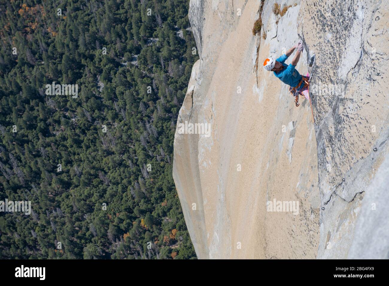 Rock climbing pulling through roof on top of The Nose El capitan Stock Photo