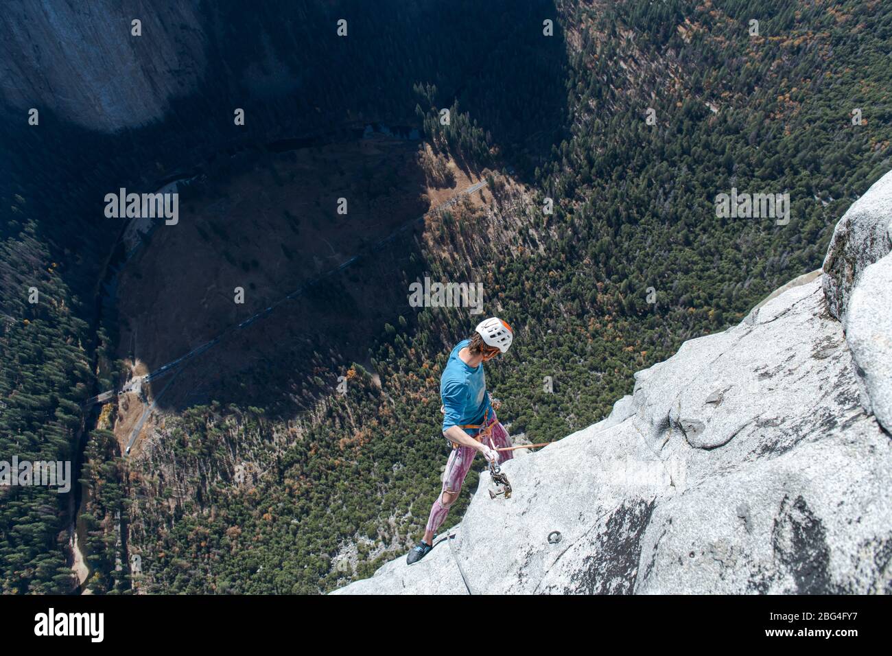 Climber looking down after climbing the nose on el capitan from top Stock Photo Alamy