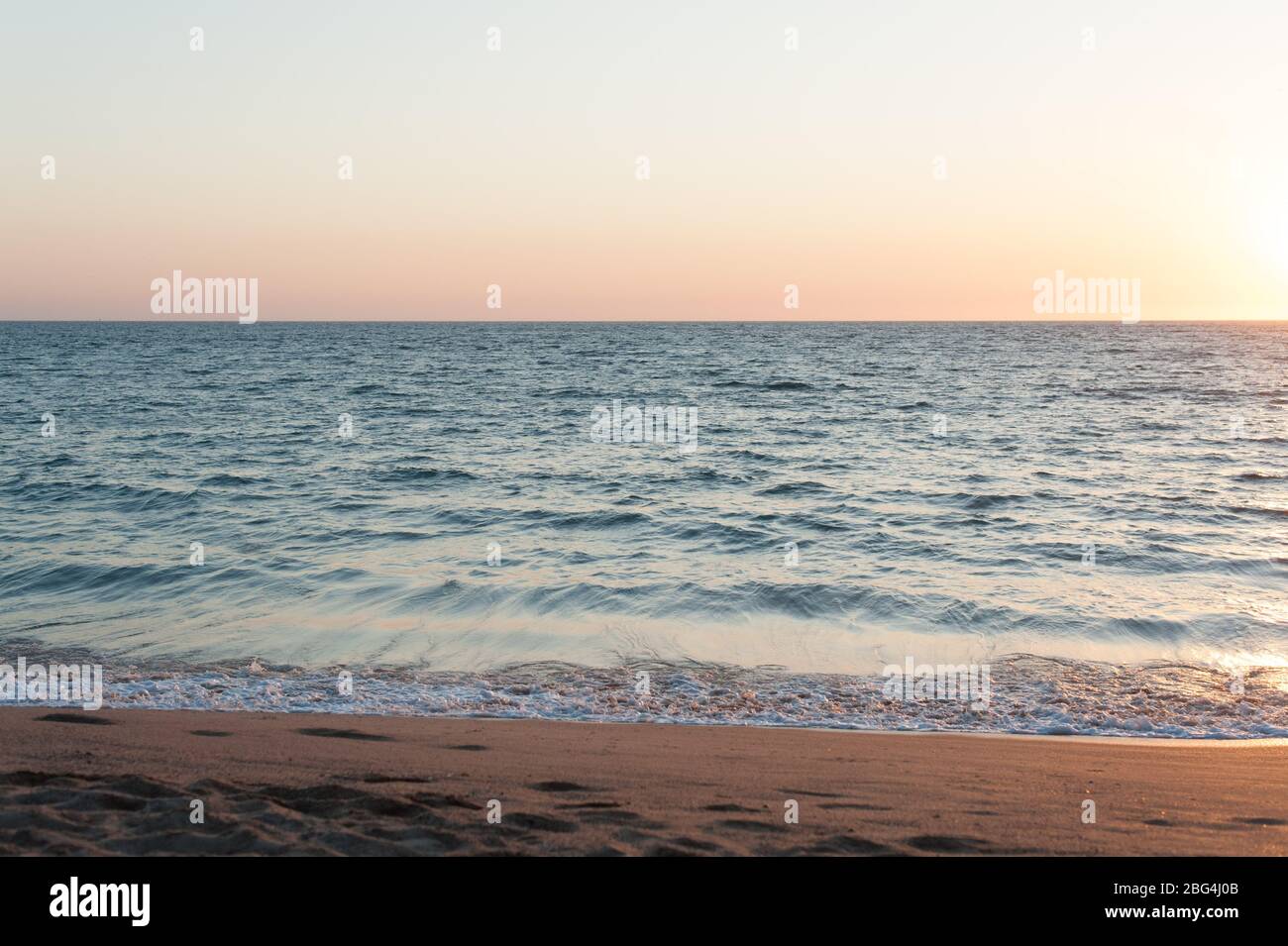 Sun setting over pacific ocean at beach  in Mexico Stock Photo