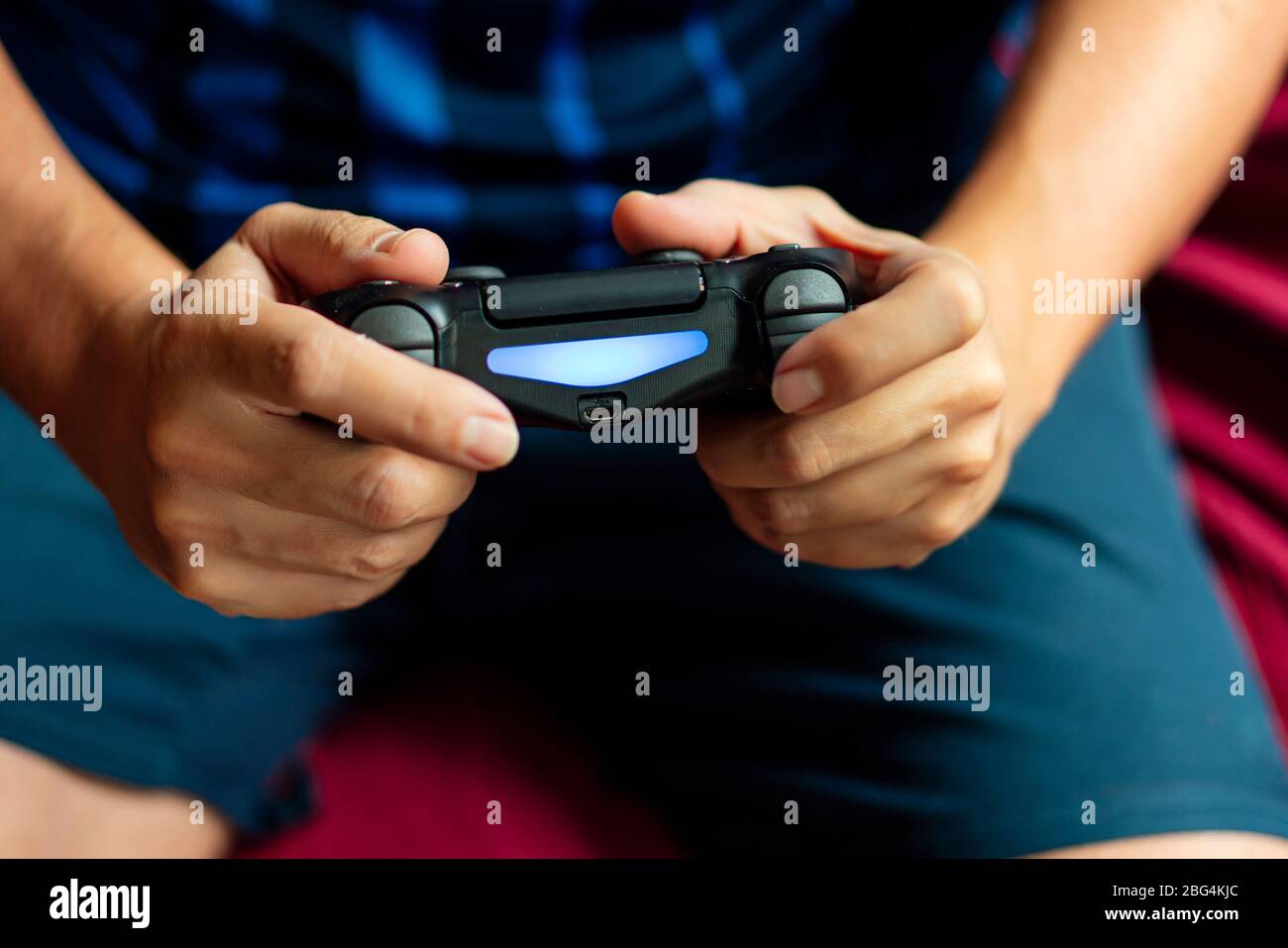 Close-up of a person playing the game console in the quarantine period ...