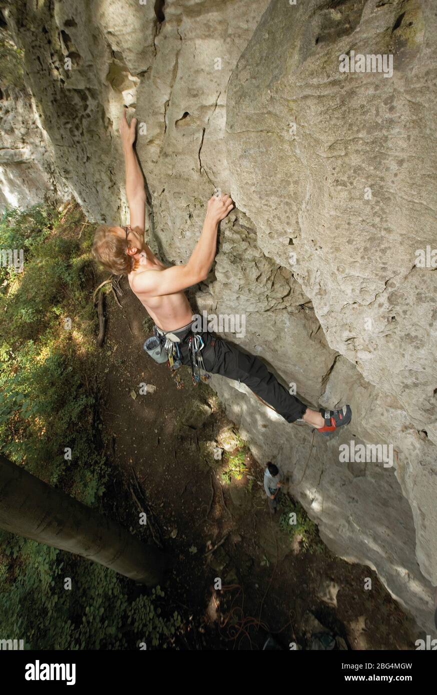 young man climbing limestone cliff in North Germany Stock Photo
