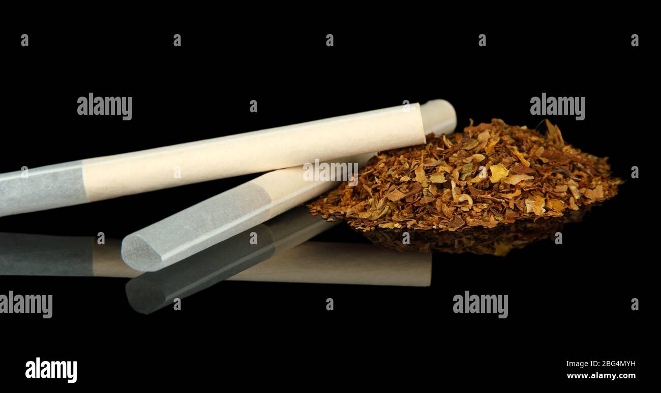Tobacco and empty cigarette tubes, isolated on black Stock Photo Alamy