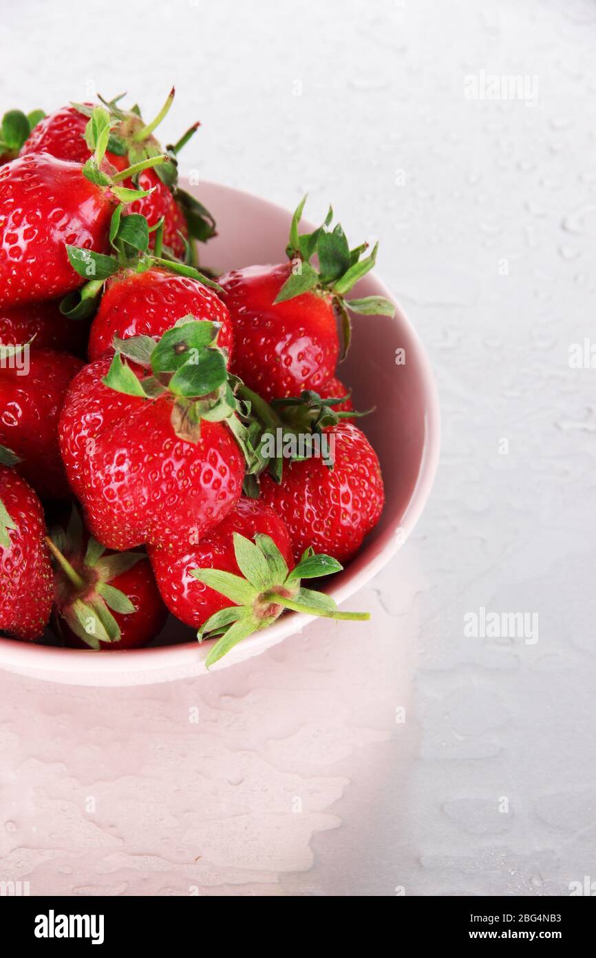 Strawberries in bowl on metal background Stock Photo - Alamy