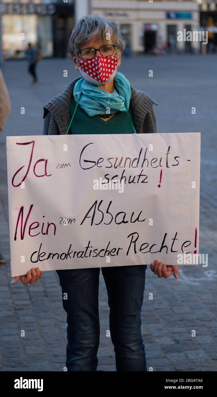 Leipzig, Germany. 20th Apr, 2020. A participant in a demonstration to uphold the right of assembly holds a sign with the slogan "Yes to health protection! No to the dismantling of democratic rights!". Since 20.04.2020, mouthguards have been compulsory in public transport and shops in Saxony. Credit: Sebastian Willnow/dpa-Zentralbild/dpa/Alamy Live News Stock Photo