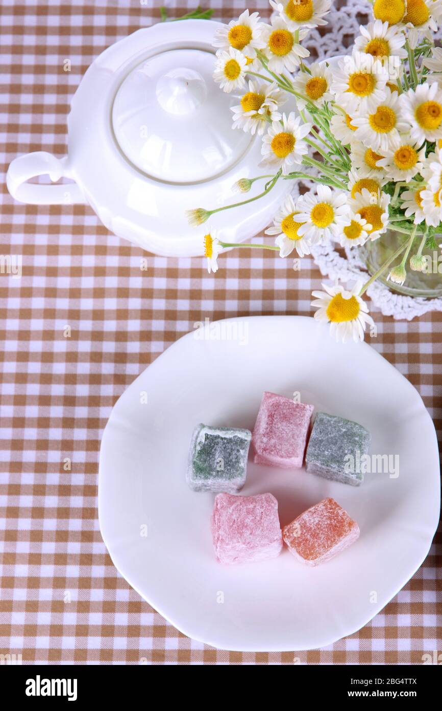 Table setting with chamomiles on checkered tablecloth Stock Photo