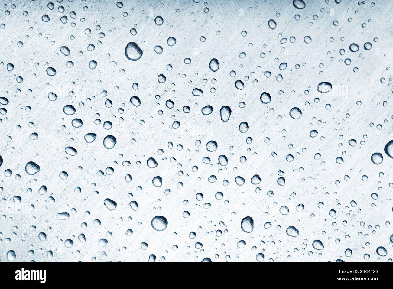 Water drops on brushed metal surface Stock Photo