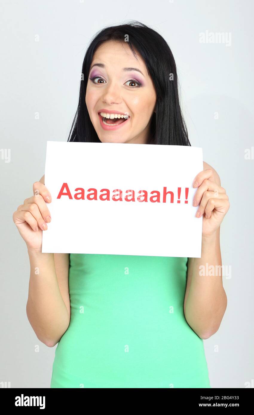 Surprised young woman holds inscription 