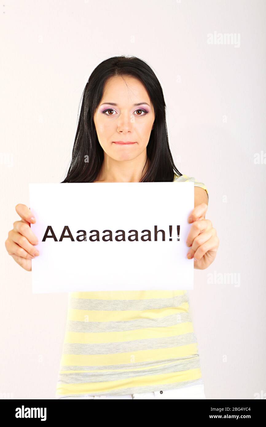 Surprised young woman holds inscription 