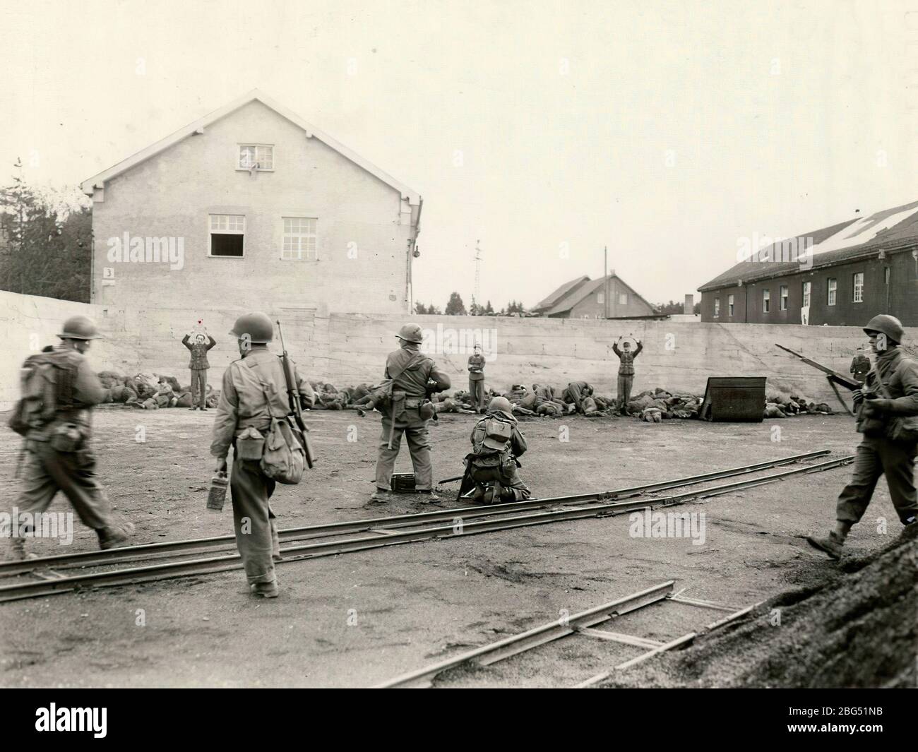 Second World War documentary. U.S. Army soldiers prepare to summarily execute SS guards of the newly liberated Dachau concentration camp on April 29, 1945. Stock Photo
