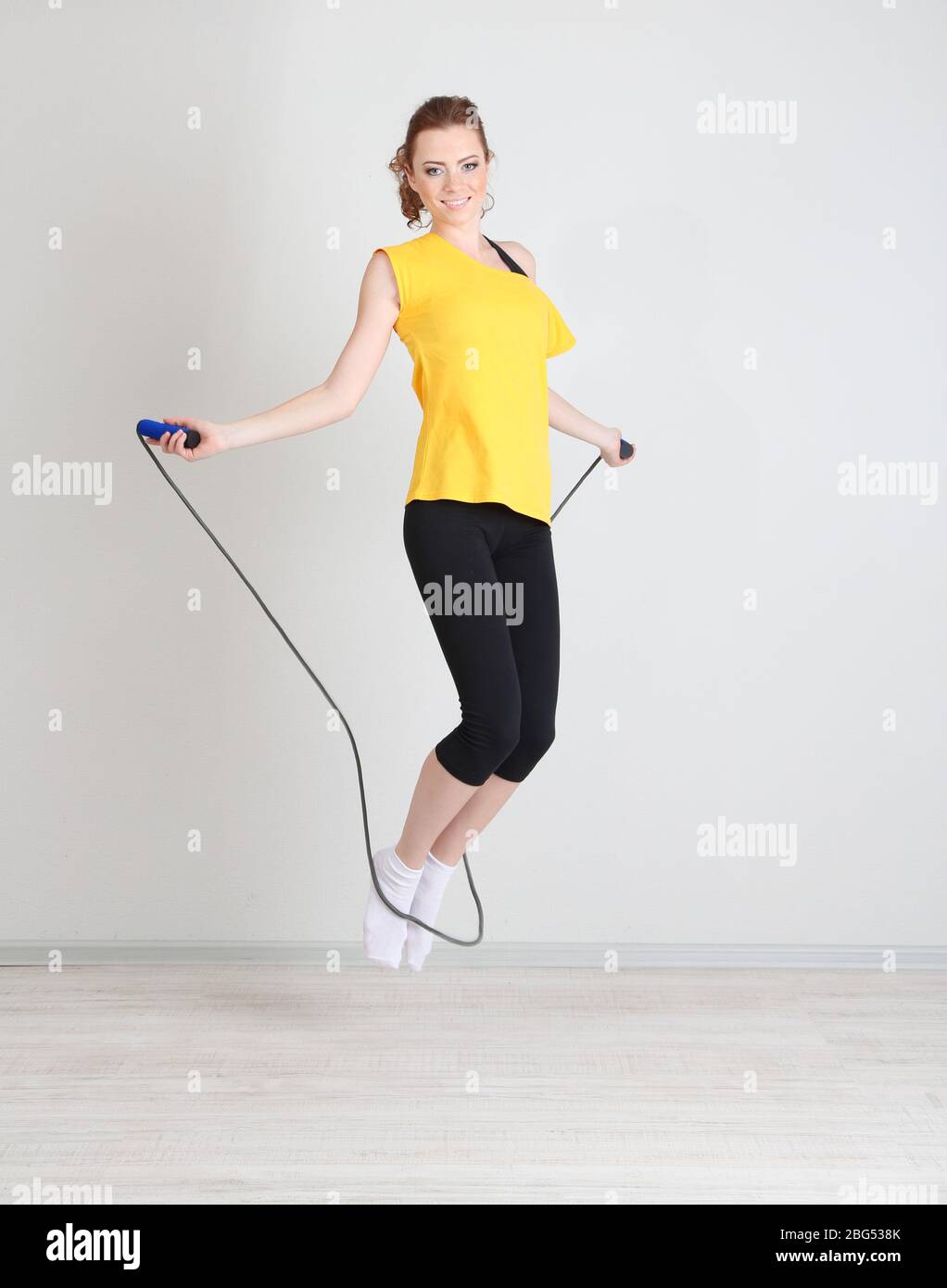 Beautiful young woman with skipping rope Stock Photo - Alamy