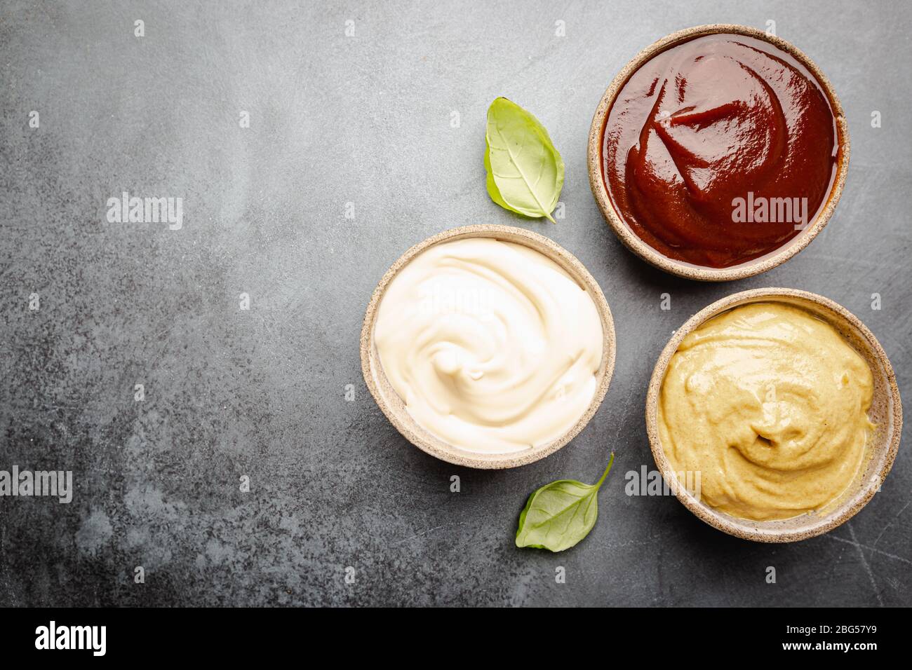 Classic set of sauces, American yellow mustard, ketchup, barbecue sauce