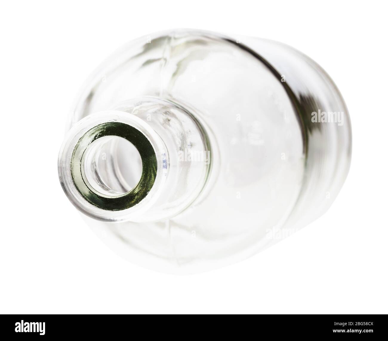 overturned empty clear brandy bottle isolated on white background Stock Photo
