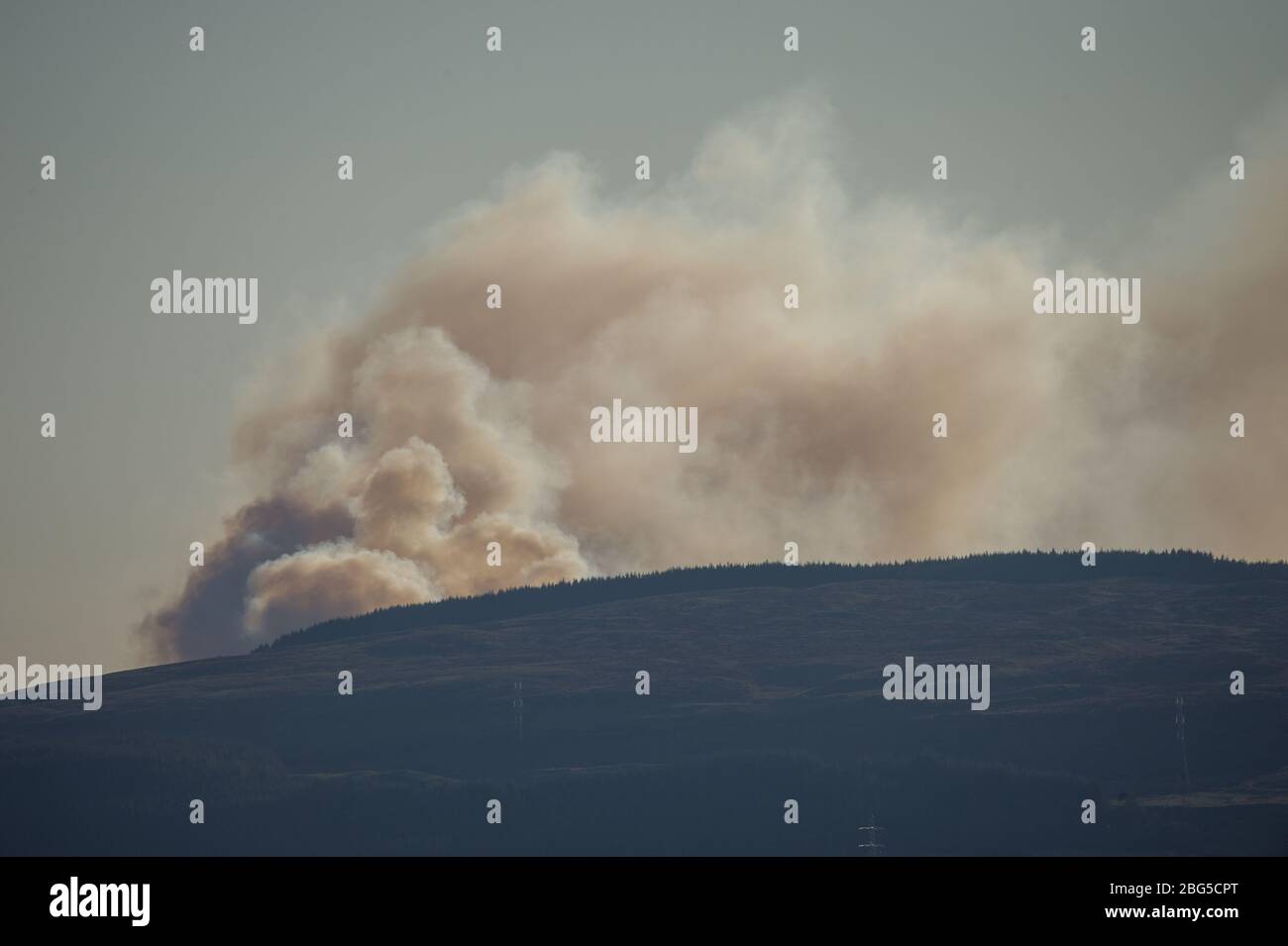 Lennoxtown, UK. 20th Apr, 2020. Pictured: Huge plumes of dark smoke billow form a massive wildfire which looks like its out of control, burns over the Kilpatrick hills in Glasgow. Credit: Colin Fisher/Alamy Live News Stock Photo