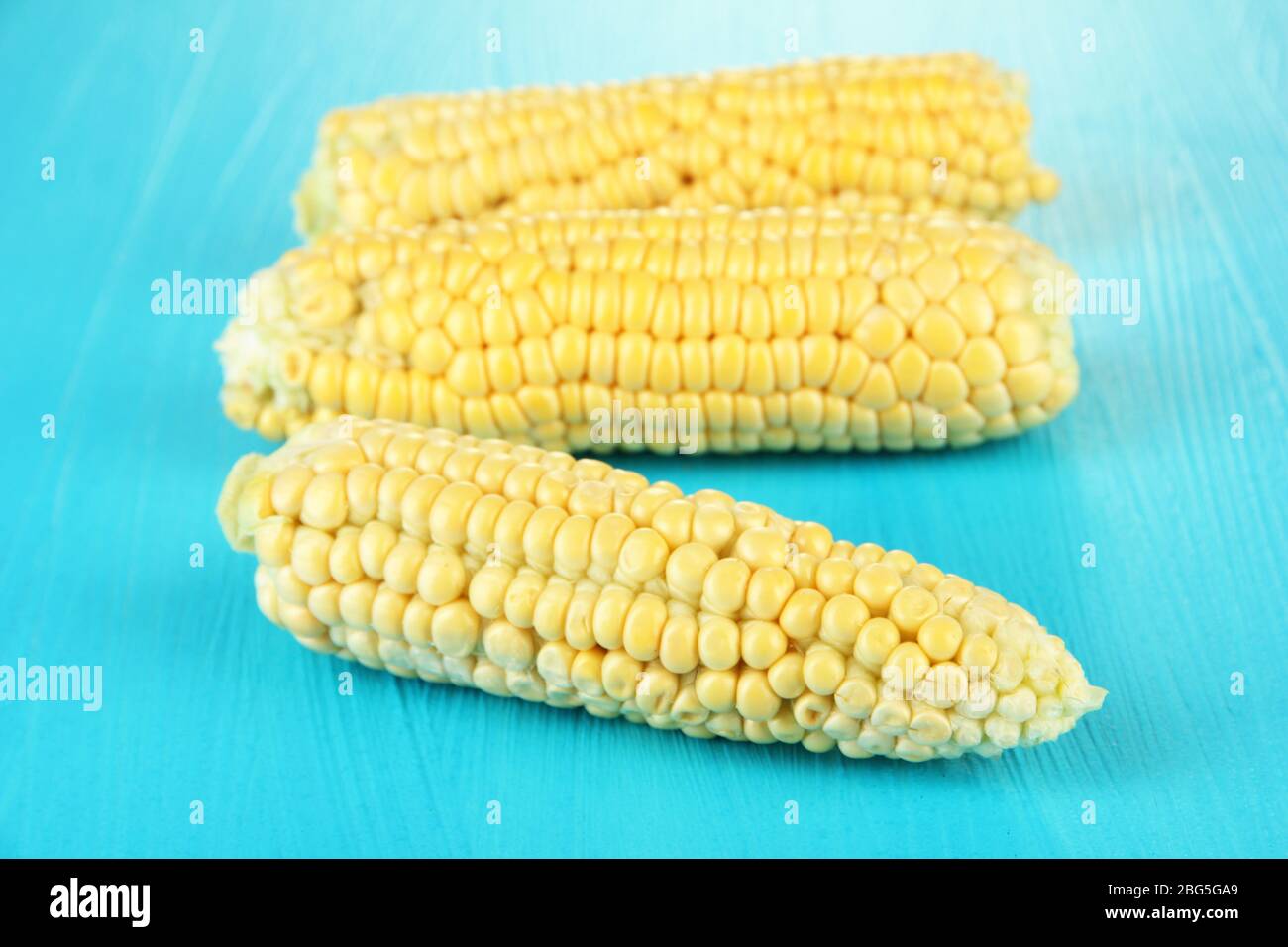 Fresh corn on color wooden background Stock Photo - Alamy