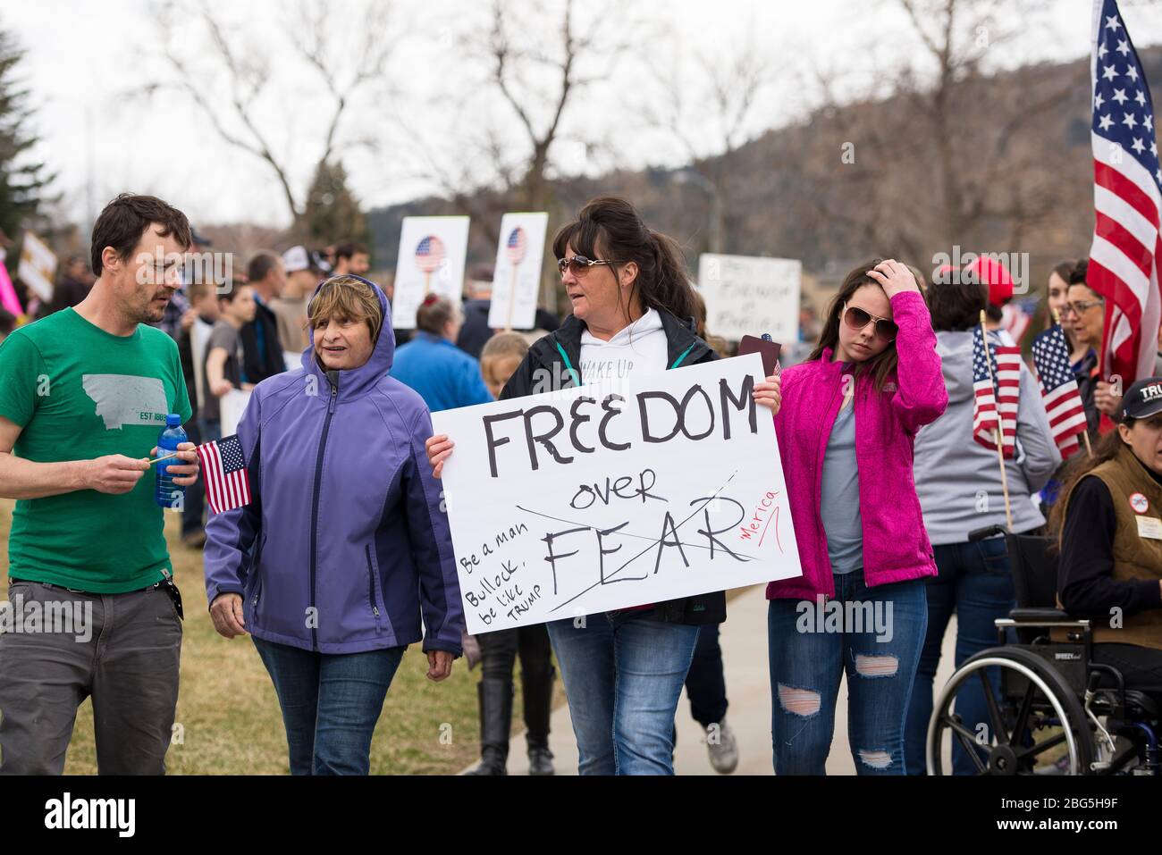 Helena, Montana - April 19, 2020: A woman protesting and holding a freedom over fear sign at a Rally during the Coronavirus government shutdown. A cro Stock Photo