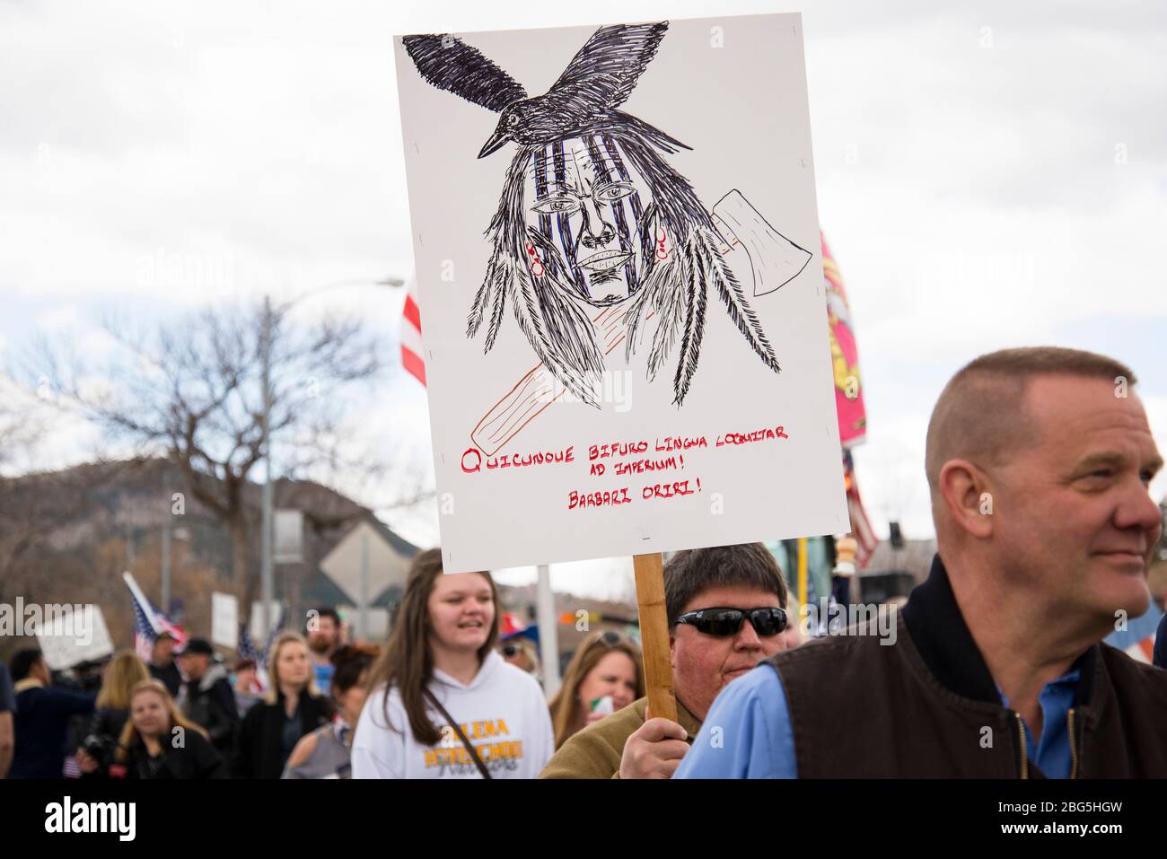 Helena, Montana - April 19, 2020: A Native American protestor holding sign that reads Government speaks with a forked tongue. Natives rise. at a prote Stock Photo