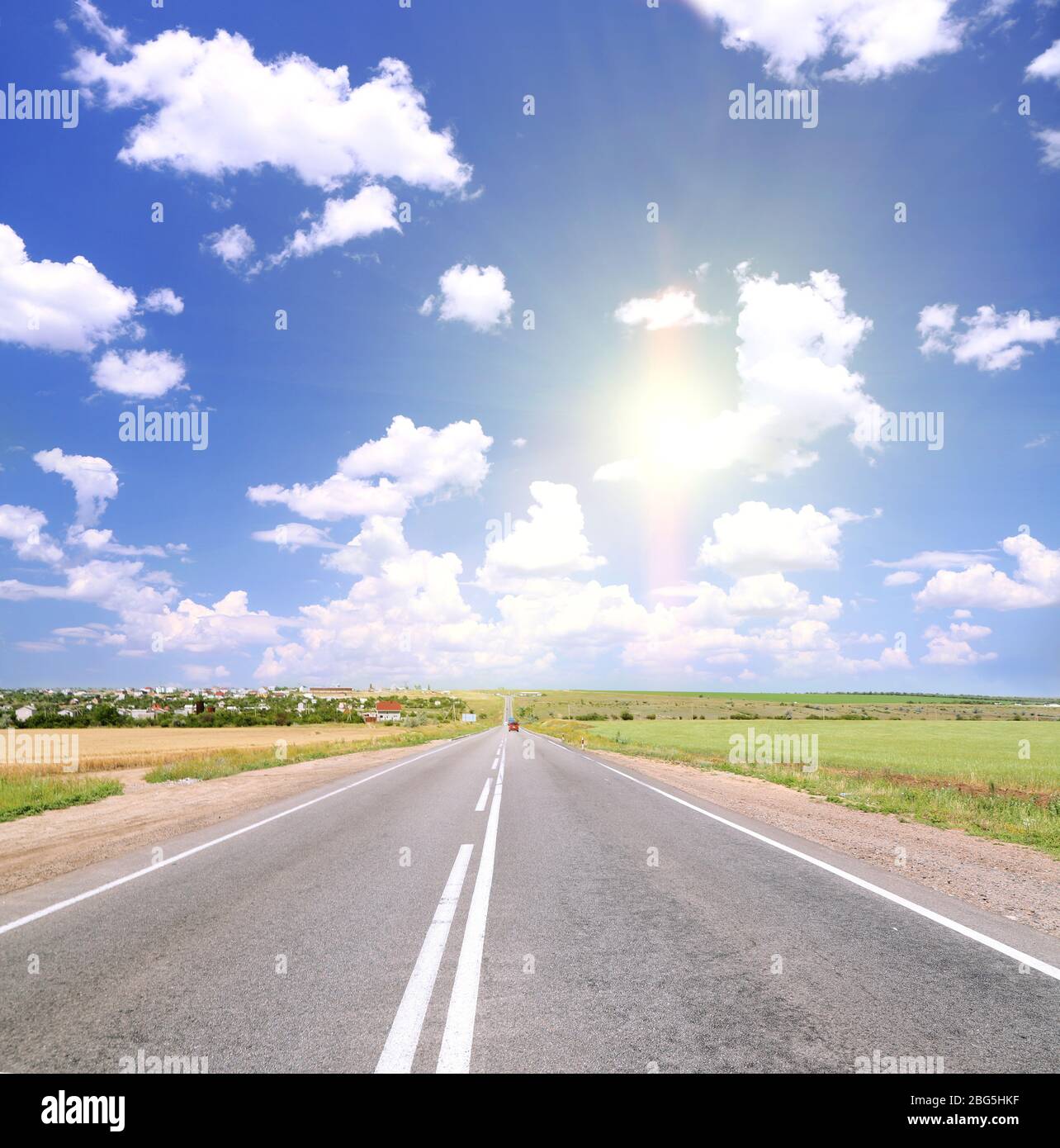 Road through the green field Stock Photo - Alamy