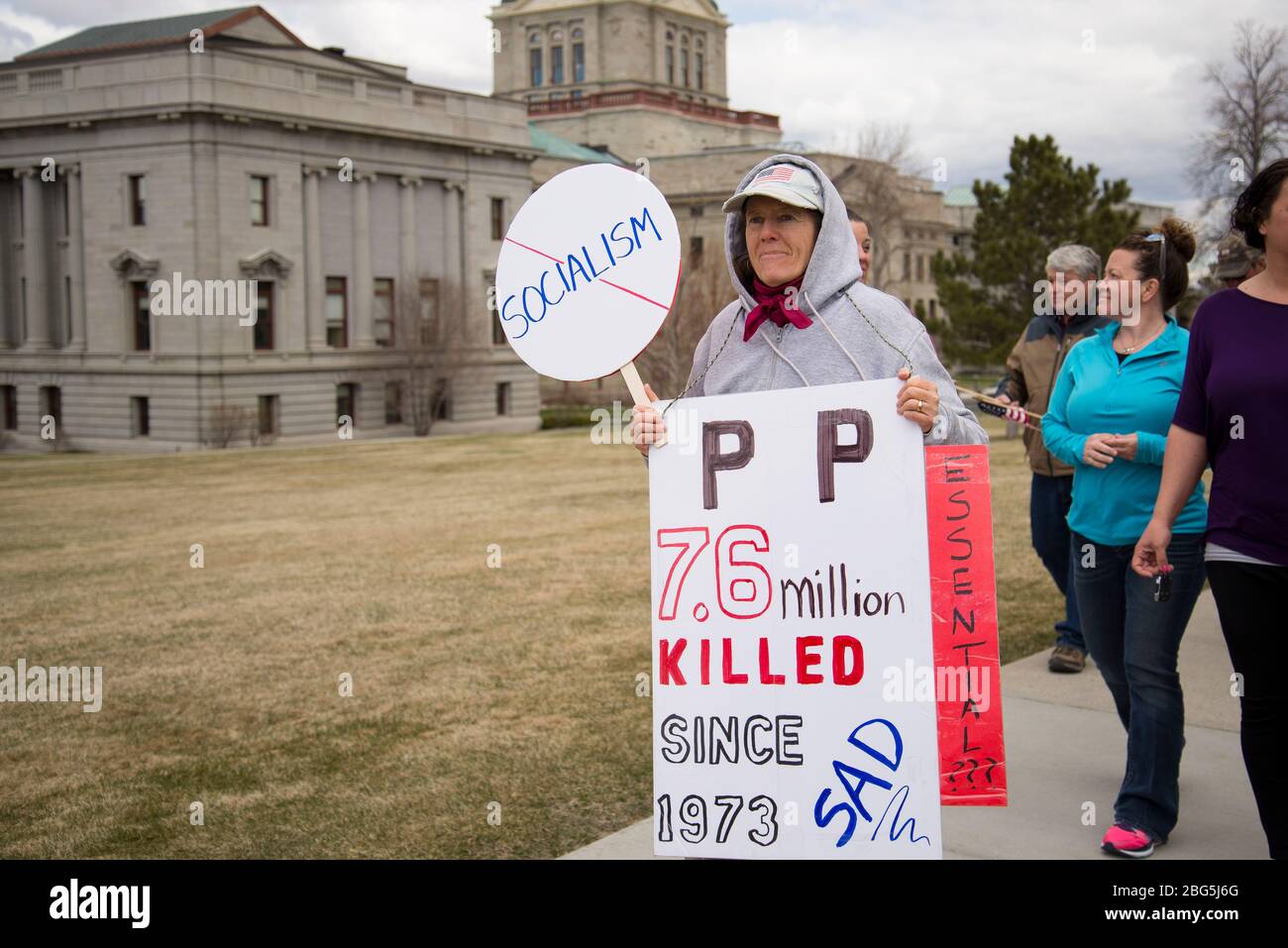 Helena, Montana - April 19, 2020: Protestor holding Planned Parenthood abortion deaths sign at a demonstration of the government shutdown of non essen Stock Photo