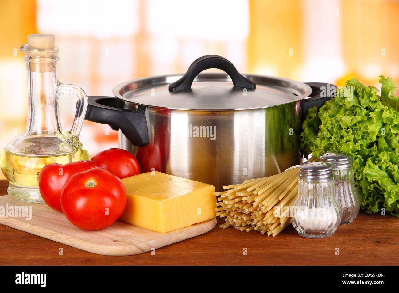 Ingredients for cooking pasta on table in kitchen Stock Photo - Alamy
