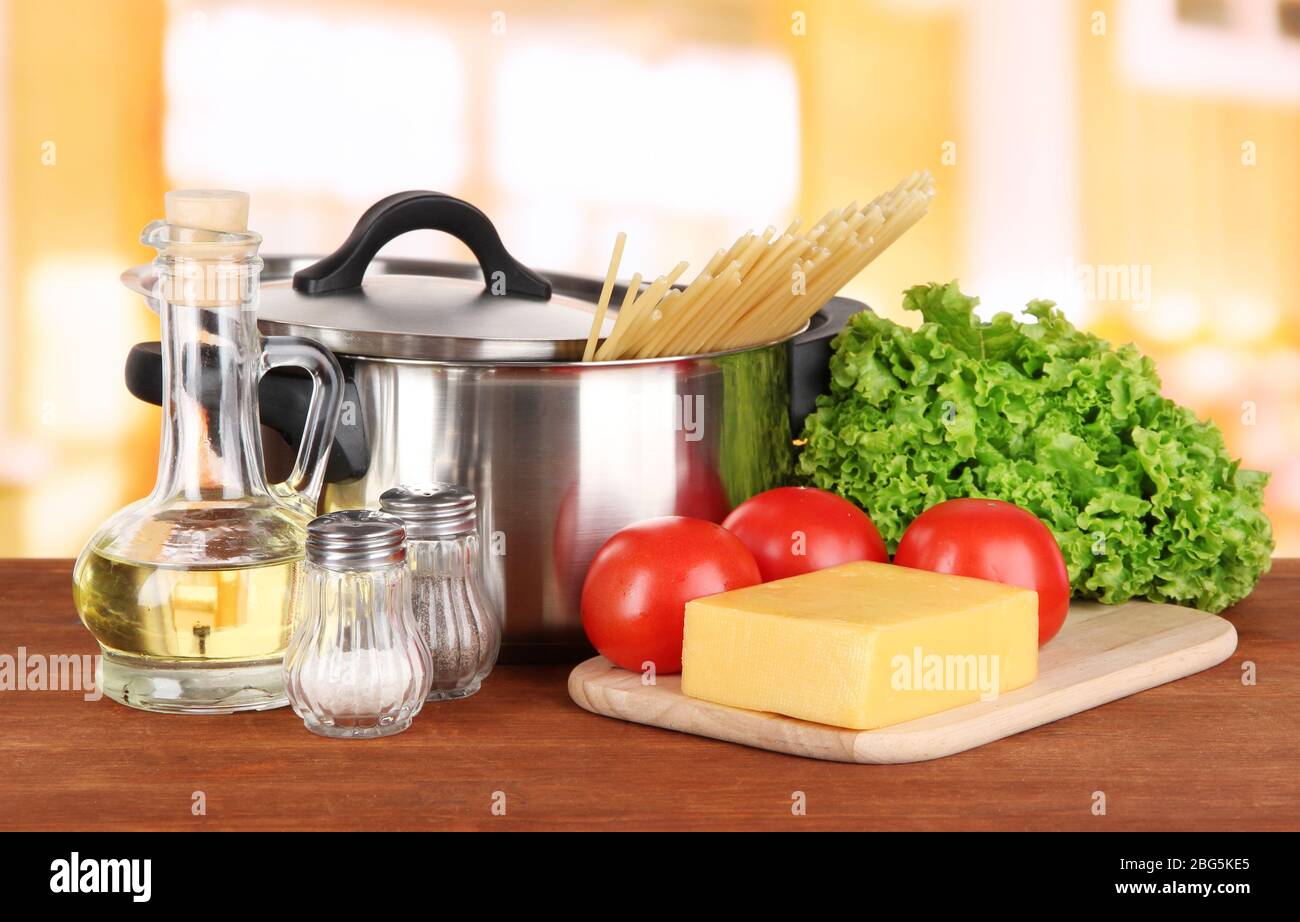 Ingredients for cooking pasta on table in kitchen Stock Photo - Alamy