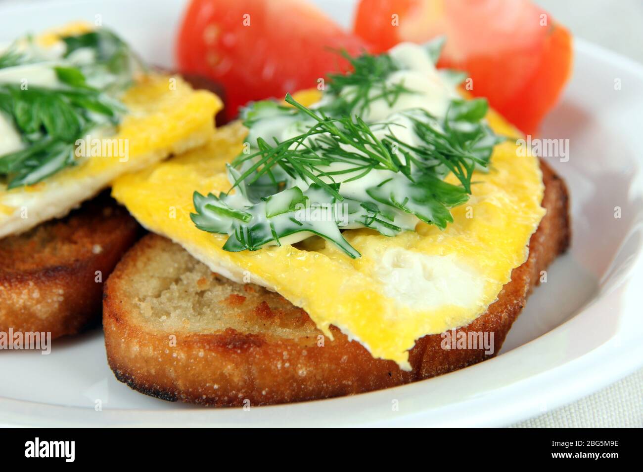 Scrambled eggs and toast on plate close-up Stock Photo - Alamy