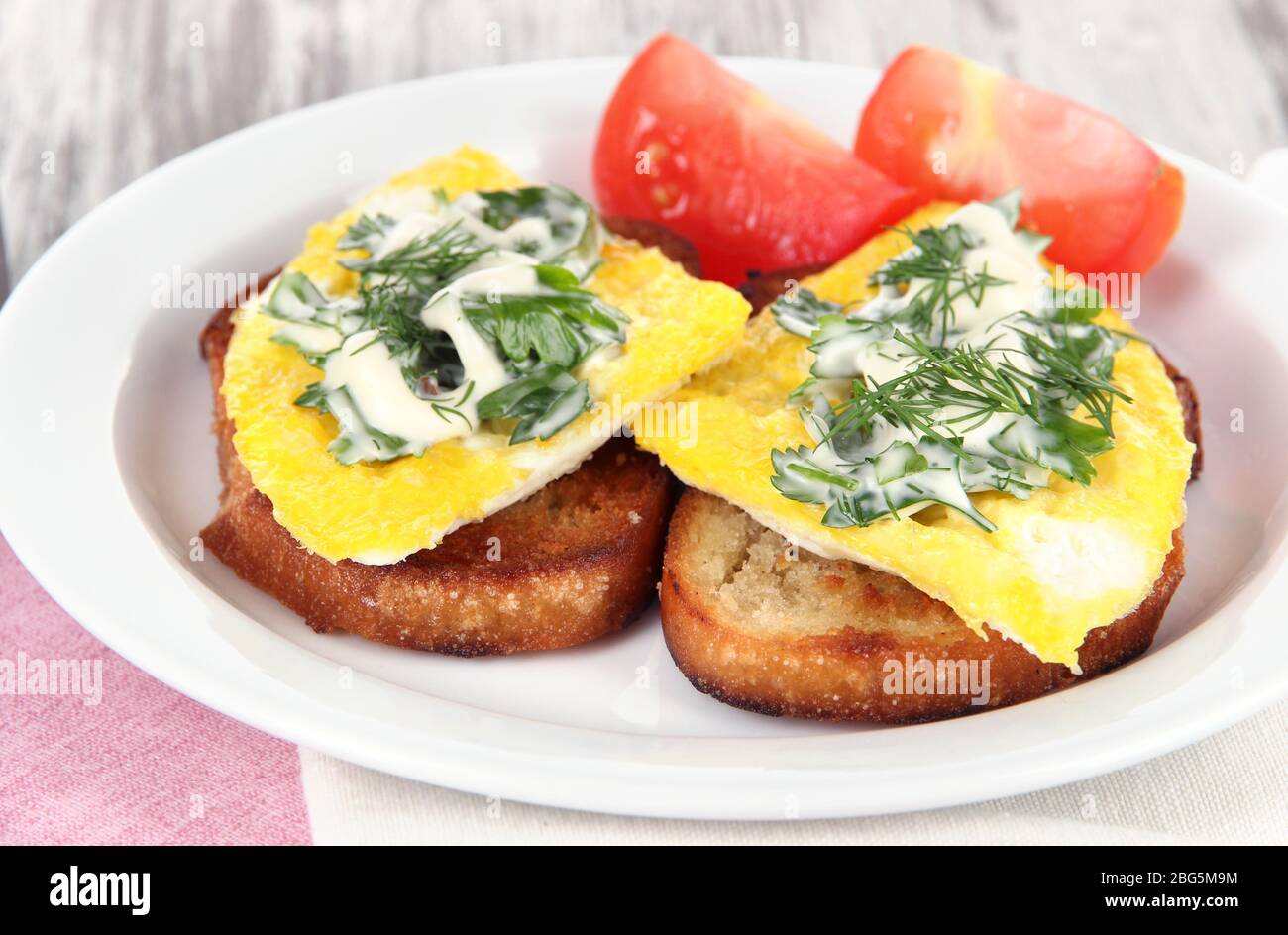 Scrambled eggs and toast on plate close-up Stock Photo - Alamy