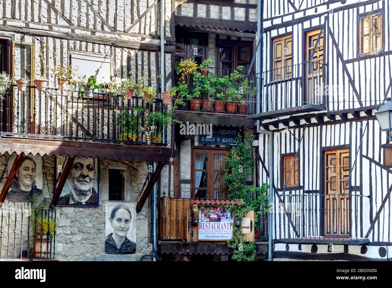 Portraits of Mogarraz. Images of neighbors past and present guard the streets of this charming alpine village. Stock Photo