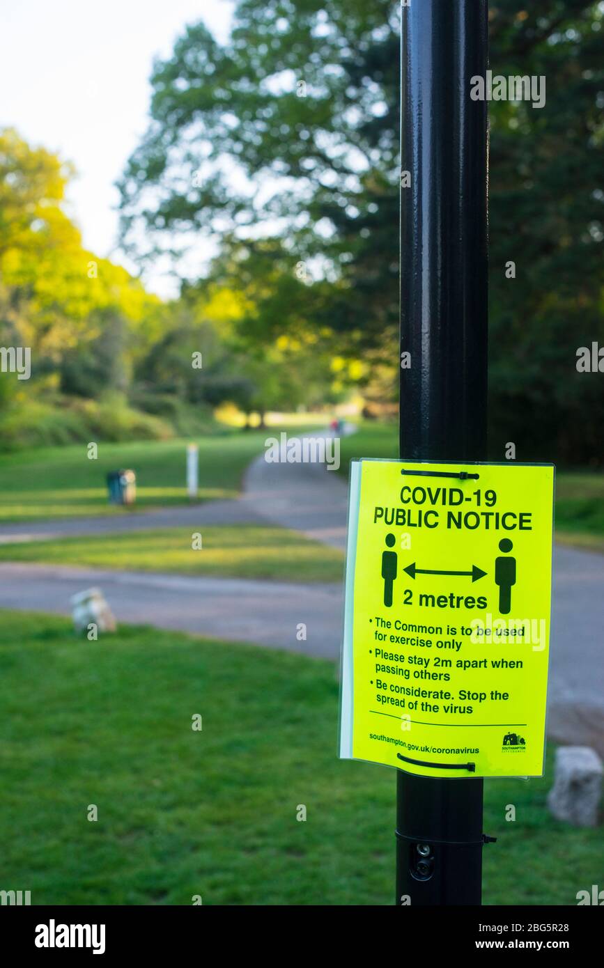 Social distancing: a sign on Southampton Common advising visitors to stay at least two metres apart to prevent the spread of Covid-19 virus Stock Photo