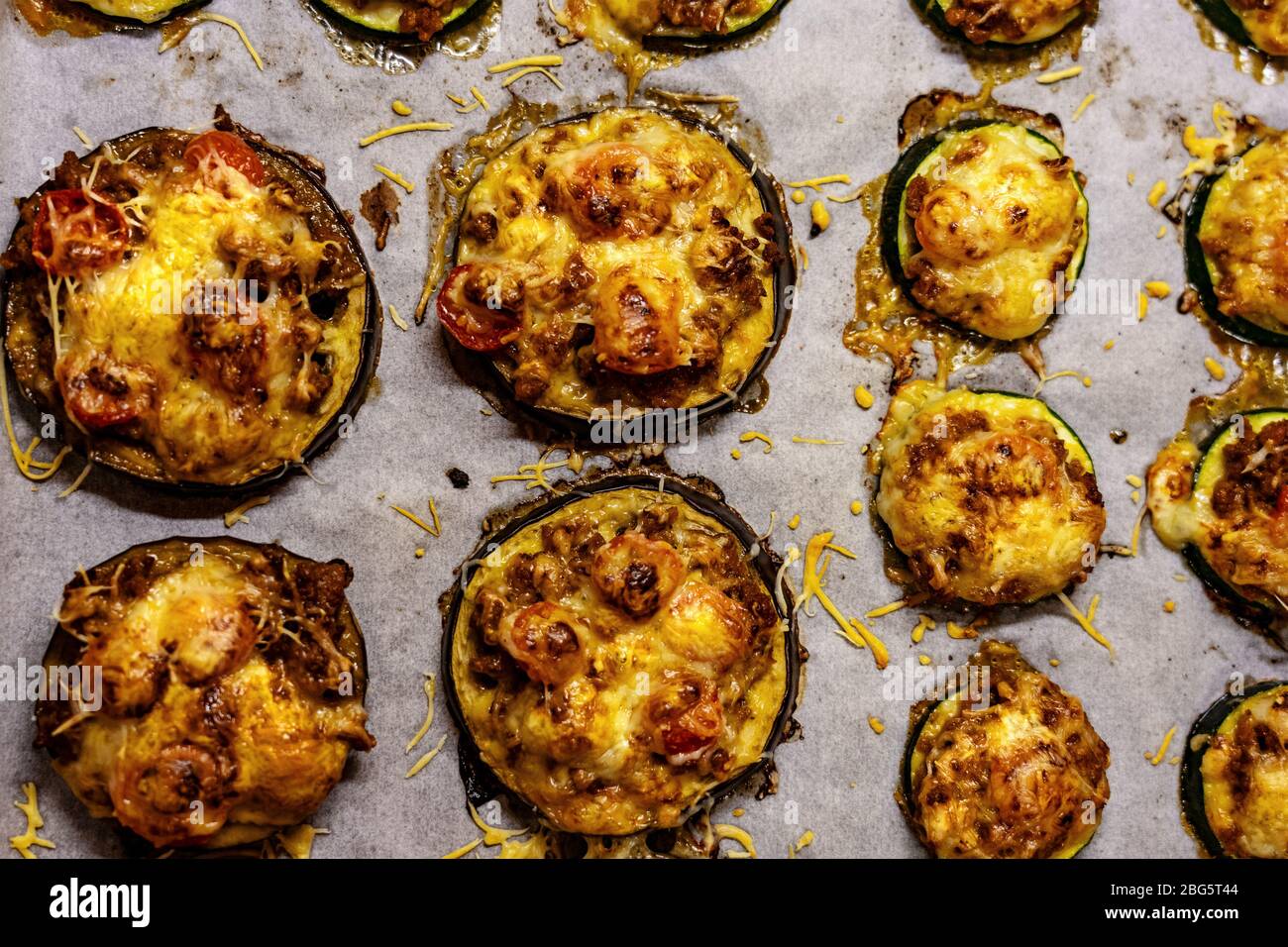 healthier alternative for pizza little round zucchini and egglant base with cheese and tomato Stock Photo