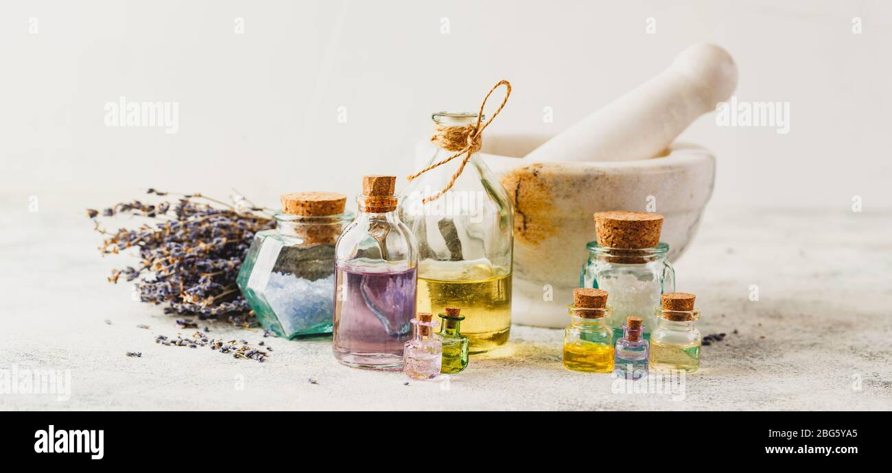 Aromatic oils in glass bottles, aromatic salts, marble mortar and dry