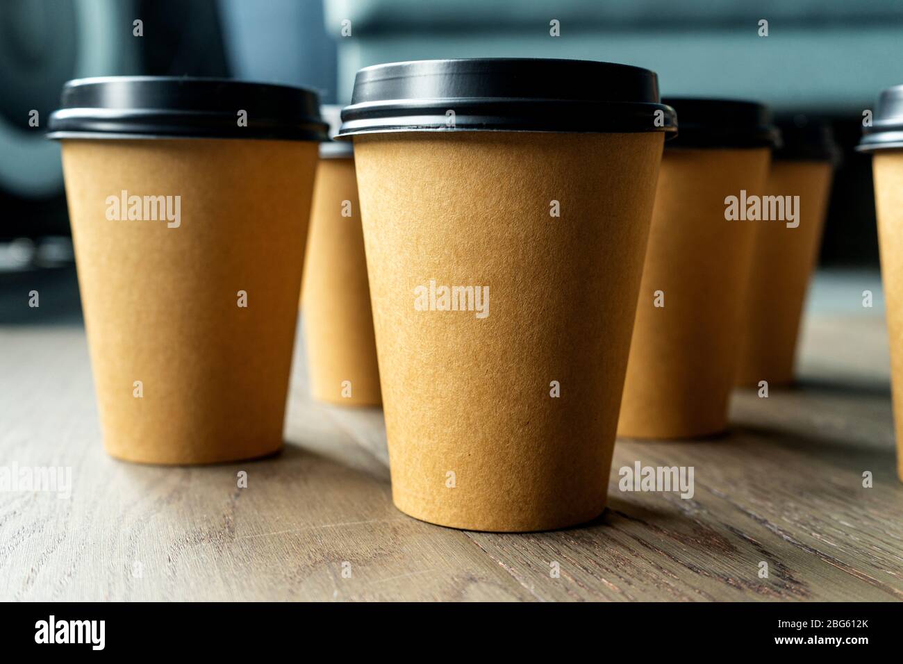 Download Disposable Cups Of Coffee On A Wooden Table Brown Paper Cup With Black Lid Stock Photo Alamy