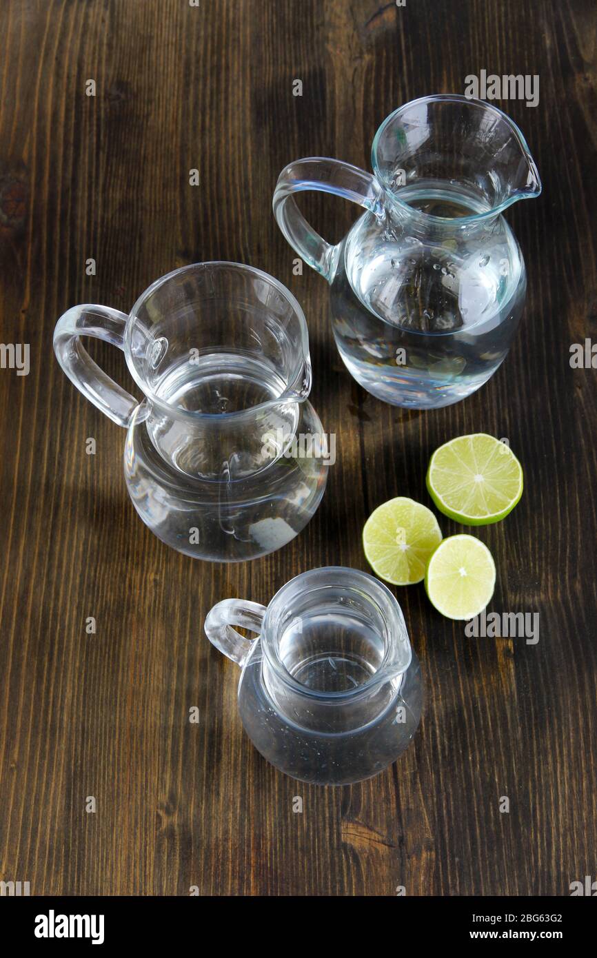 Glass pitchers of water on wooden table close-up Stock Photo - Alamy