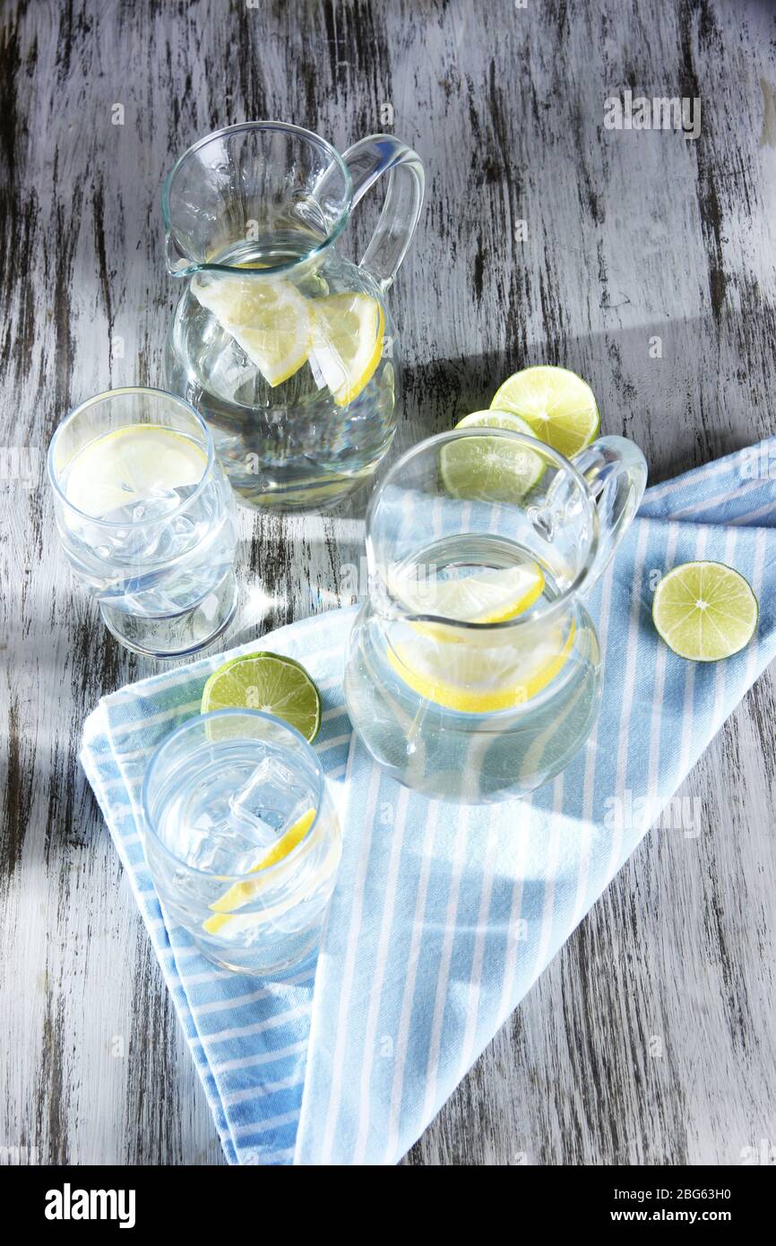 Glass pitchers of water and glasses on wooden table close-up Stock ...