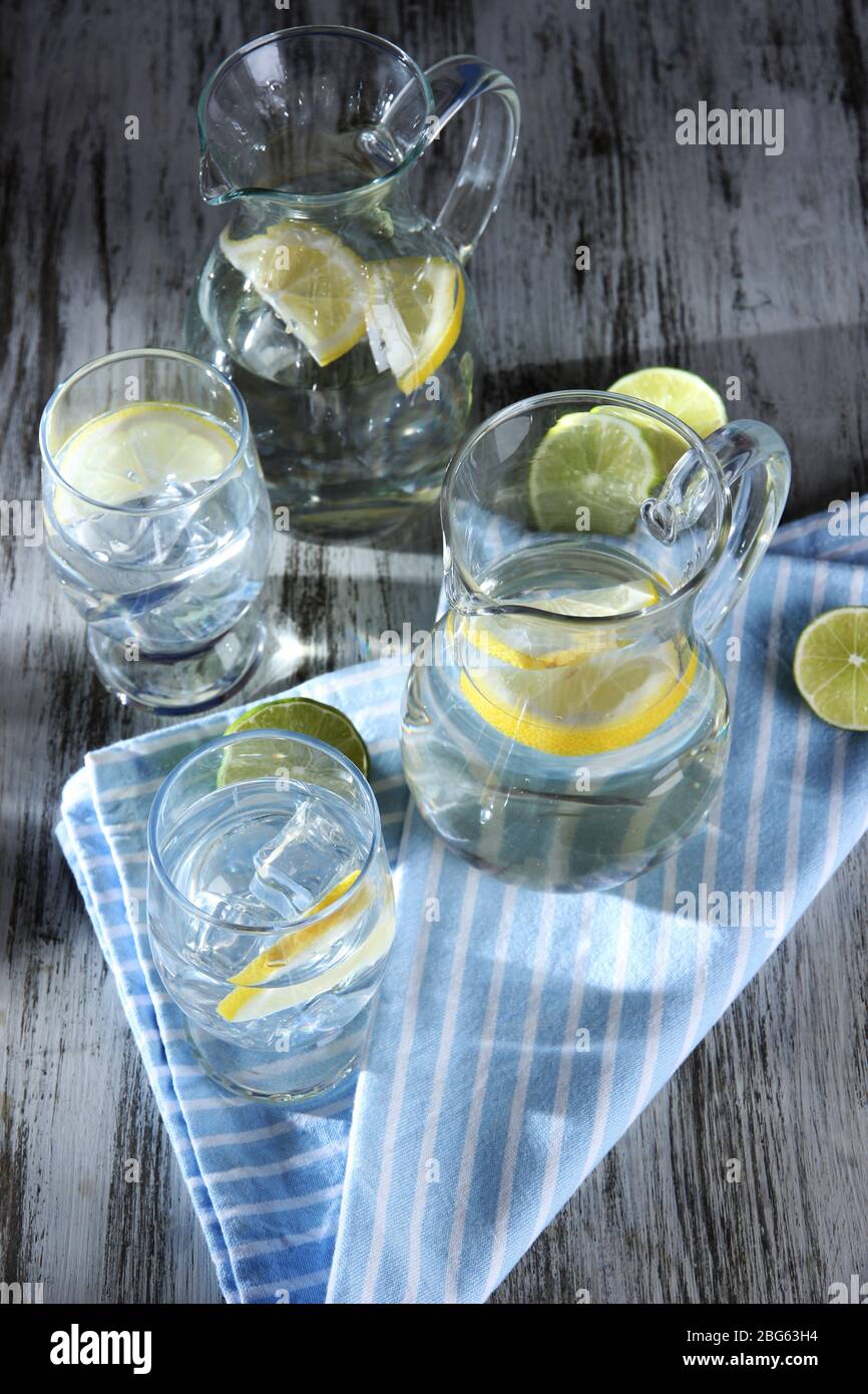 Glass pitchers of water and glasses on wooden table close-up Stock ...