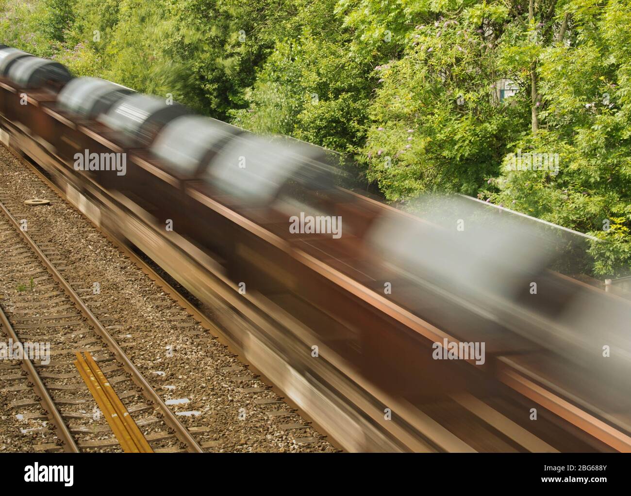 Cardiff, Wales - August 2017: The wagons of a freight train carrying steel coils with slow shutter speed to show motion Stock Photo