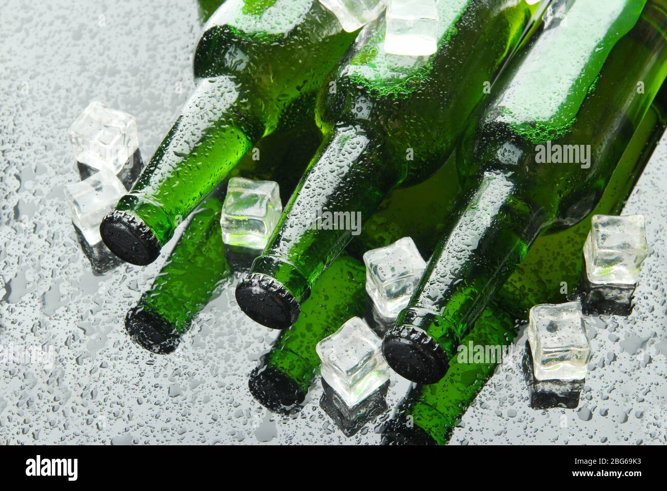 Bottles of beer with ice cubes, close up Stock Photo Alamy