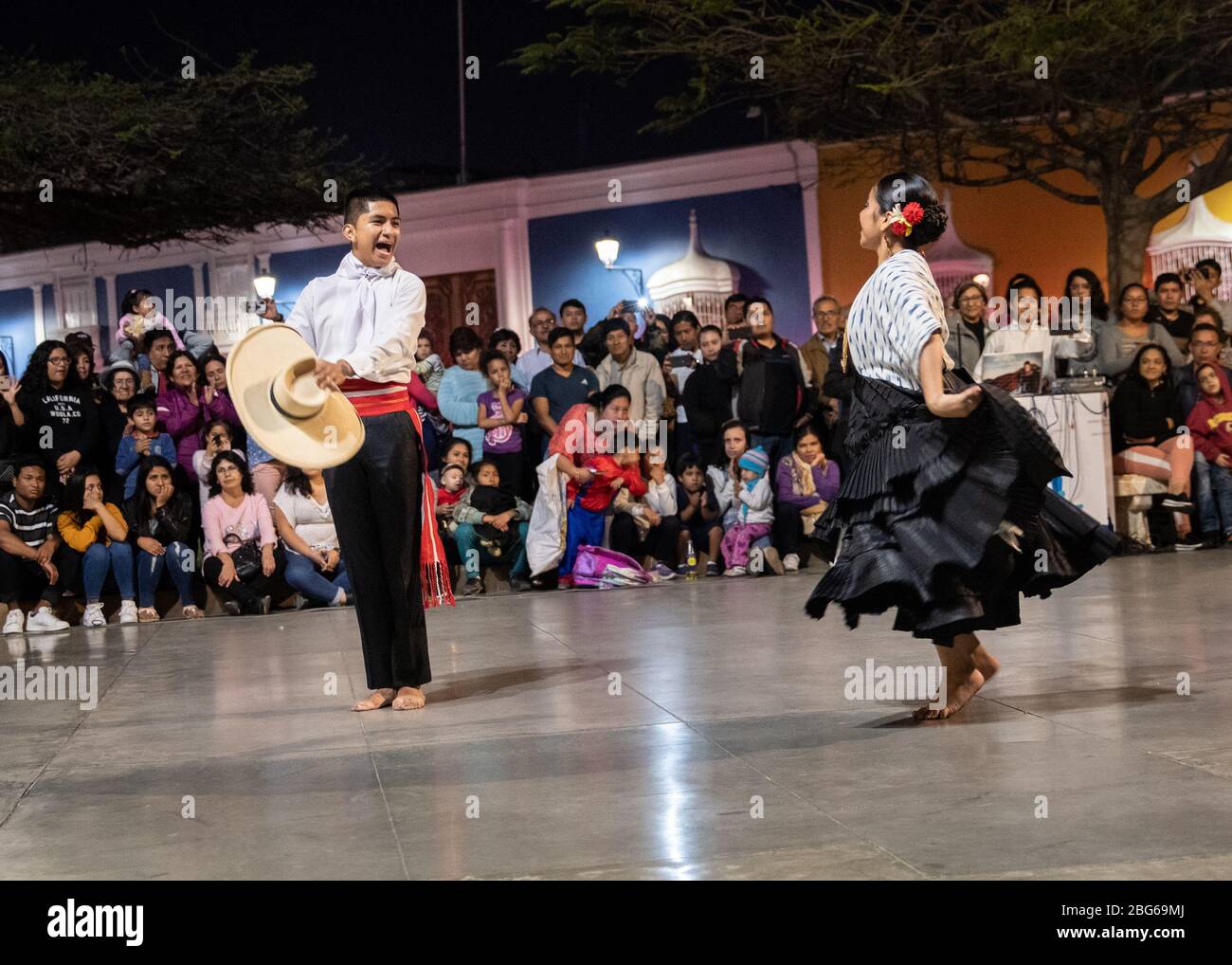 Male and Female dancers in traditional costume performing La Marinera