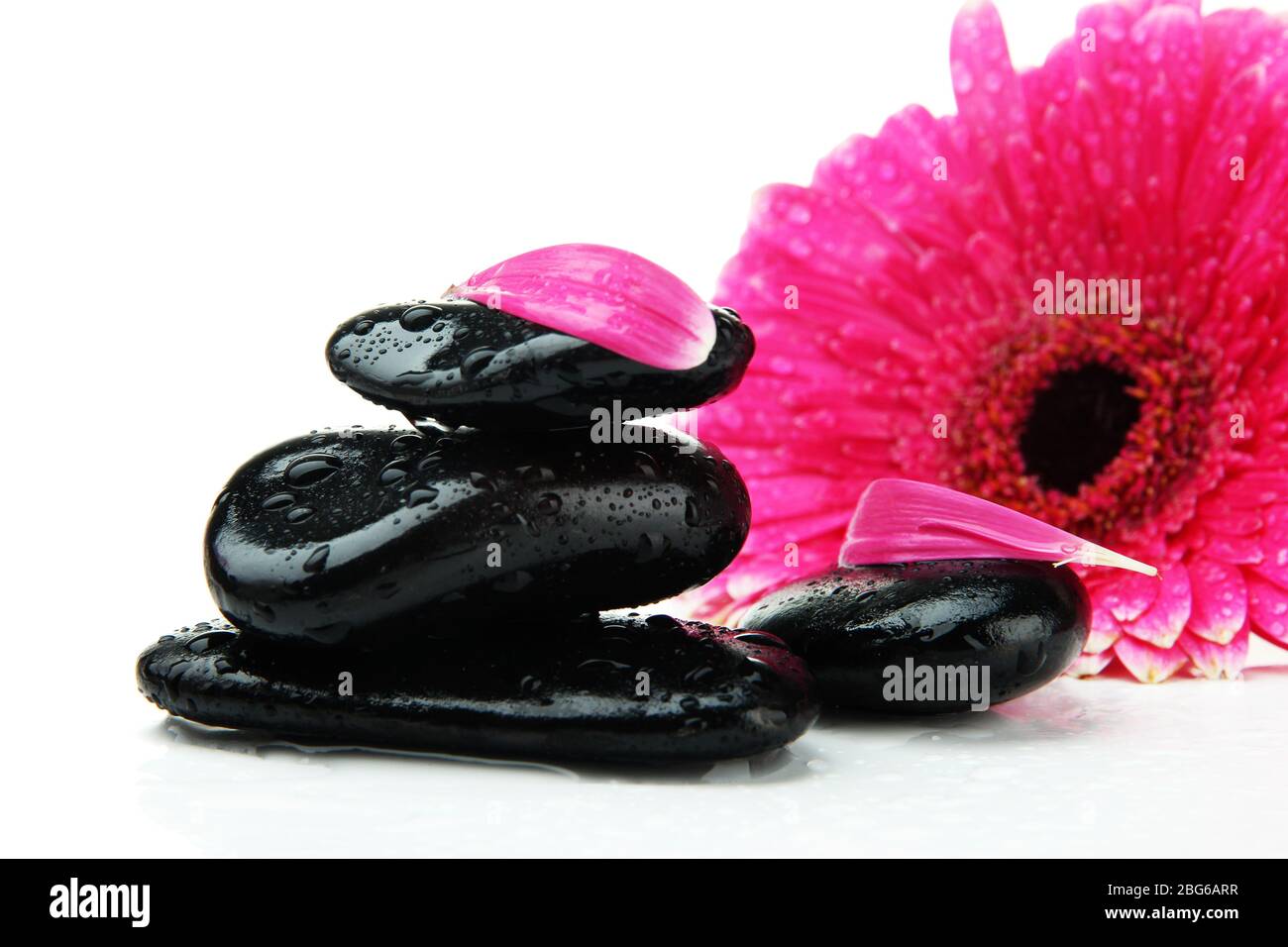 Spa stones and gerbera isolated on white Stock Photo - Alamy