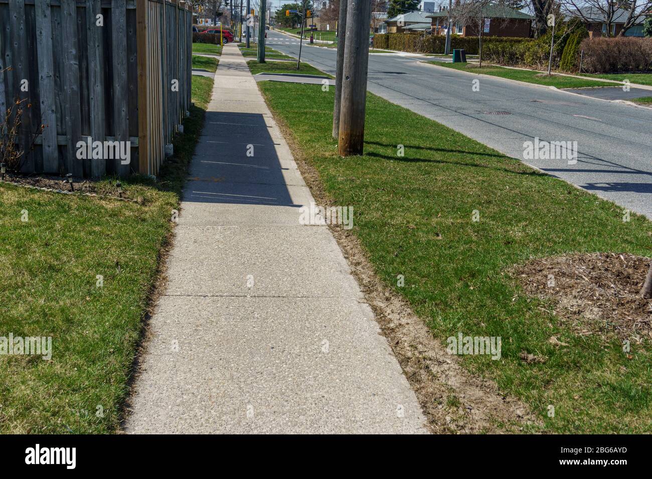 Empty and deserted road and sidewalk during the covid-19 pandemic Stock Photo