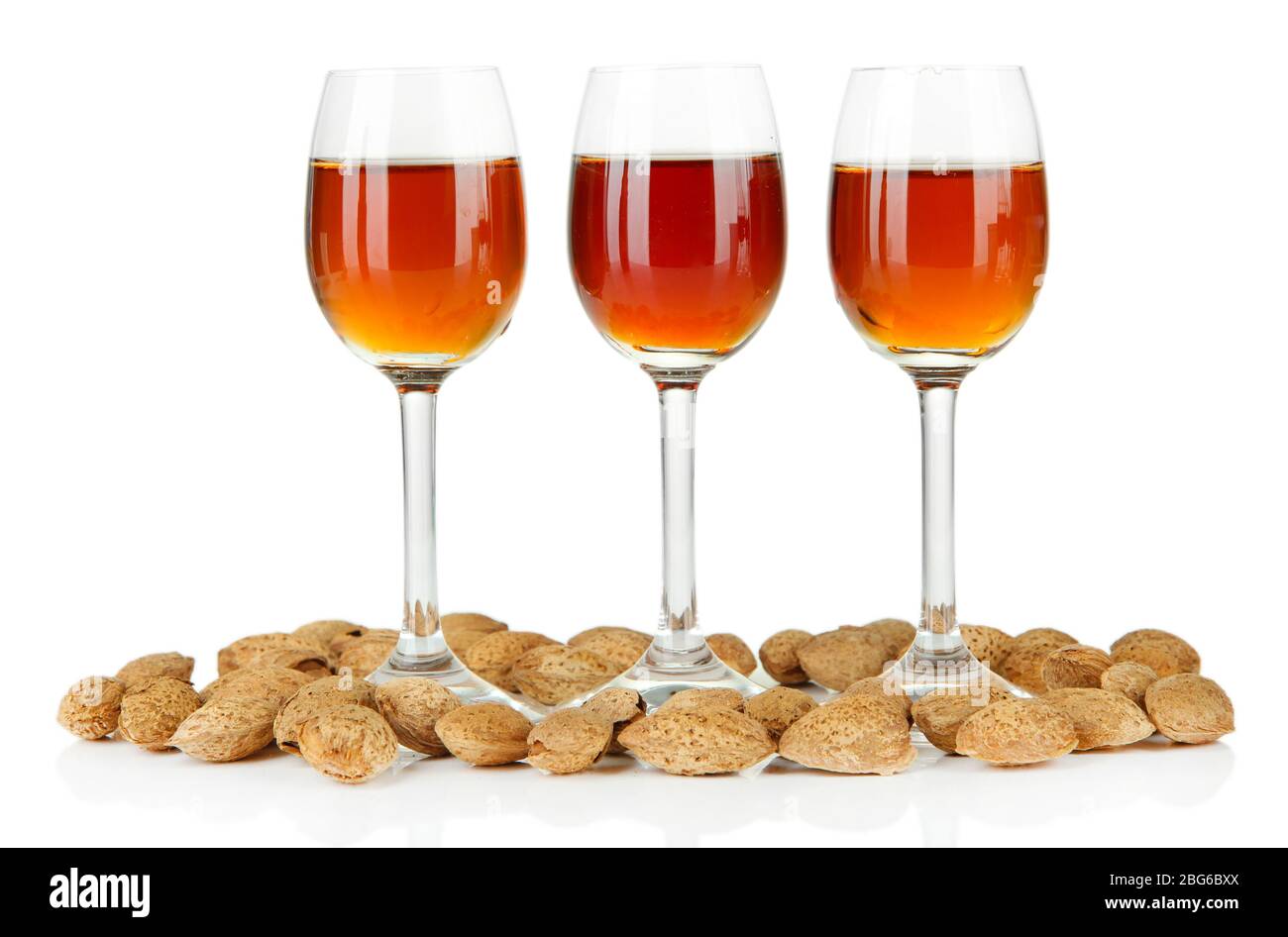Glasses of amaretto liquor and roasted almonds, isolated on white Stock