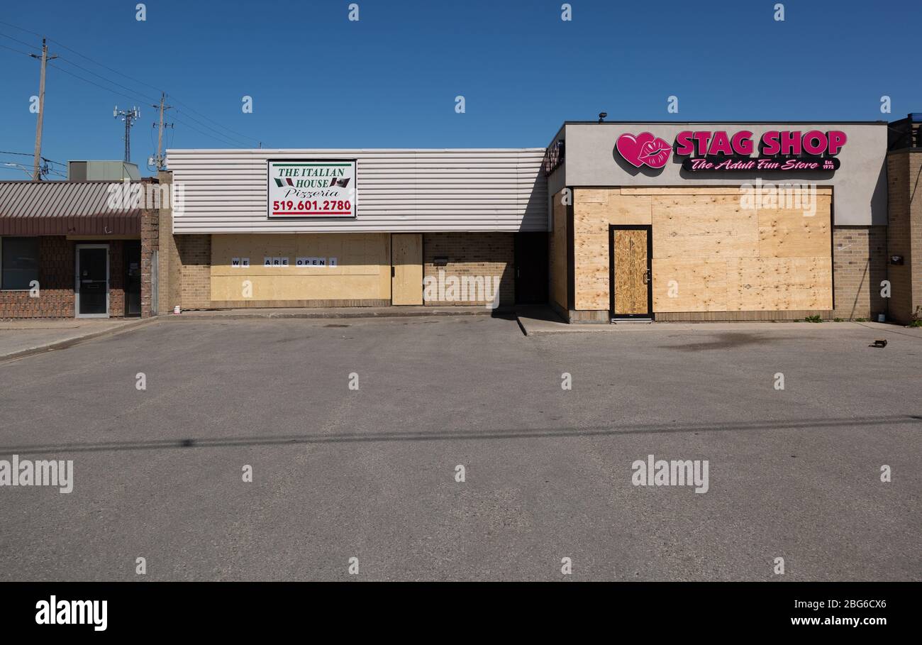 Closed and boarded up shops stores and restaurants in London, Ontario