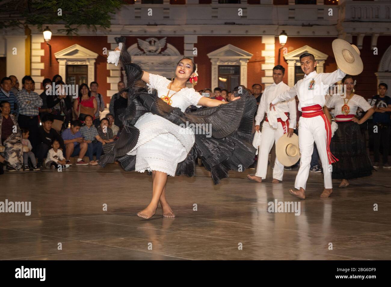 Male and Female dancers in traditional costume performing La Marinera Norteña Peruvian dance to