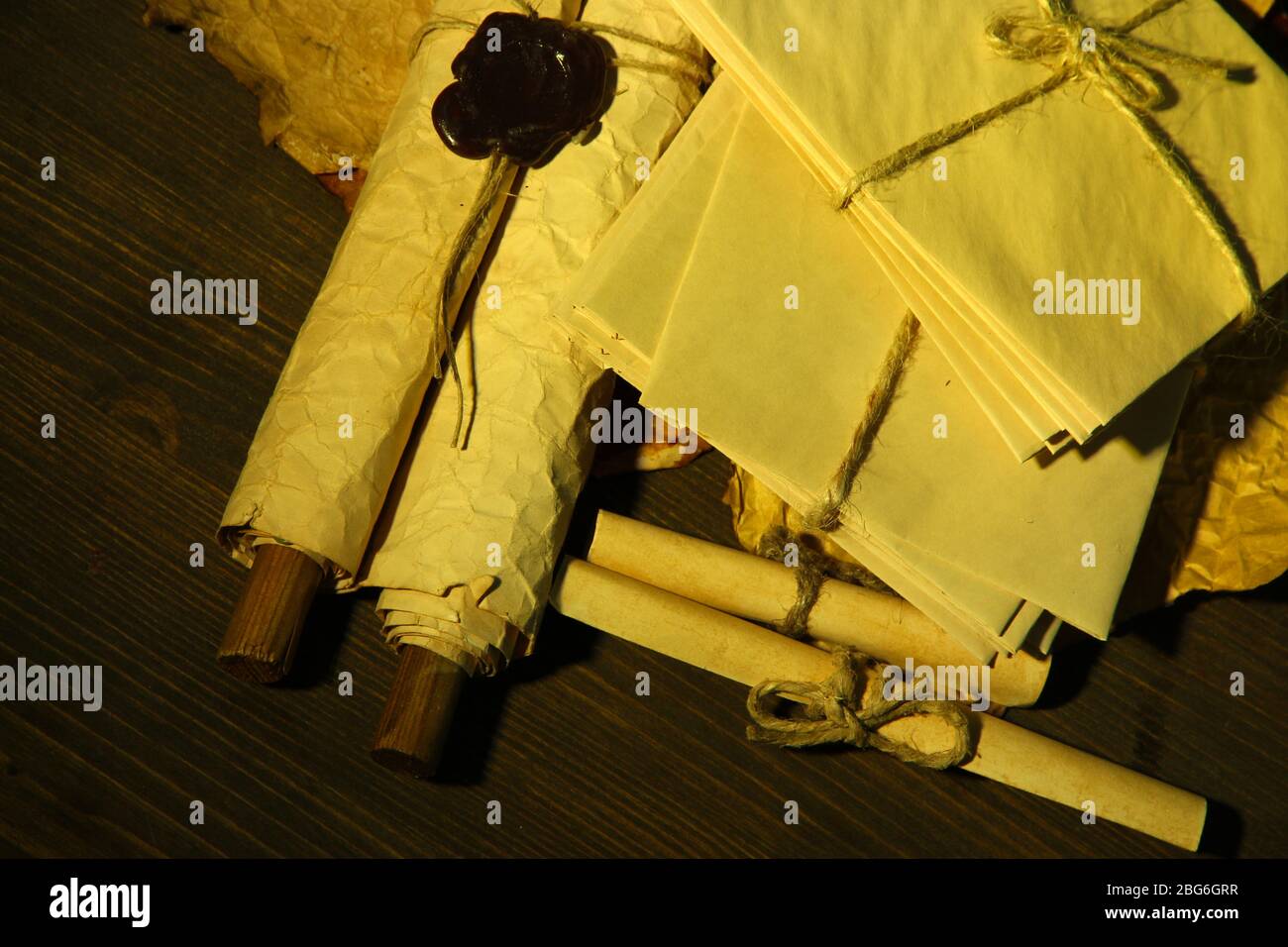 Antique scroll and letters on dark background Stock Photo - Alamy