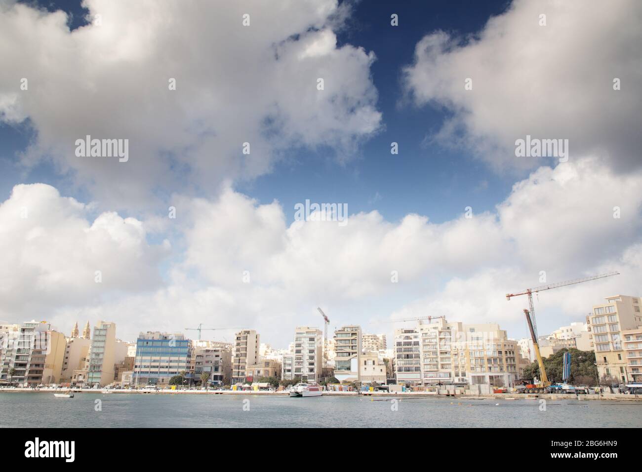 seafront along the coast of Sliema in malta with a lot of building work being done Stock Photo