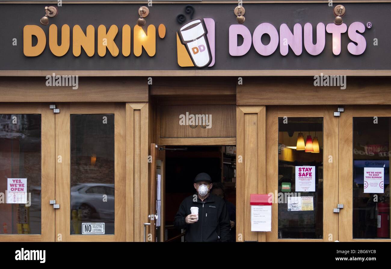 Annapolis, United States. 20th Apr, 2020. A man wears a mask as he leaves a Dunkin' Donuts store in downtown Annapolis, Maryland amid the Coronavirus COVID-19 pandemic on Monday, April 20, 2020. Gov. Larry Hogan, R-MD, recently passed an order that requires all people must wear a face covering before going into any retail establishment. Photo by Kevin Dietsch/UPI Credit: UPI/Alamy Live News Stock Photo