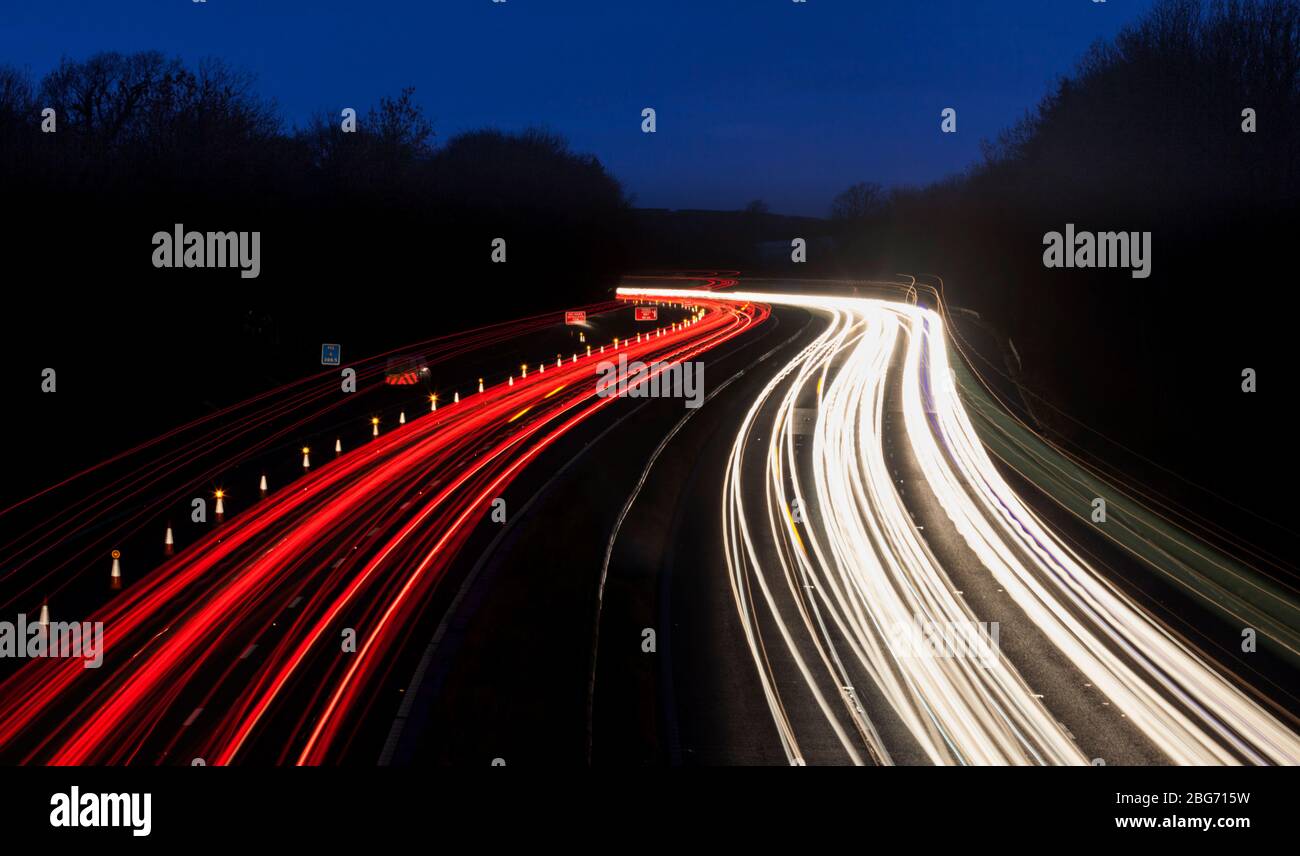 Light trails on the M6 motorway at junction 34, Lancaster  during the evening rush hour Stock Photo