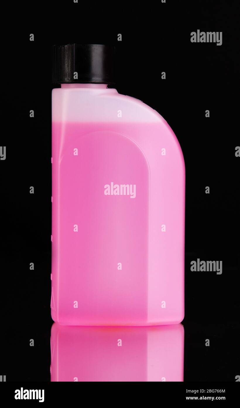 Pink liquid for car in canister on black background Stock Photo