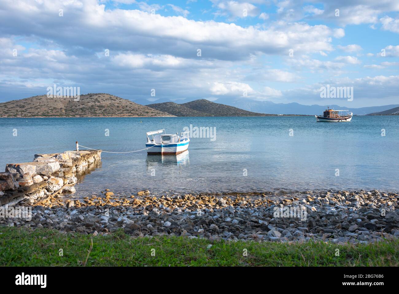 Sailing boat anchored in the peaceful gulf of Elounda, Crete, Greece. Stock Photo