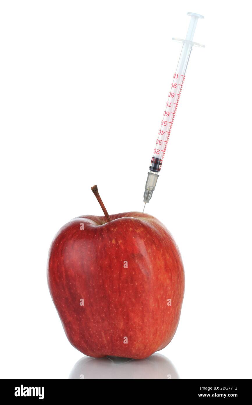 Injection into fresh red apple isolated on white Stock Photo - Alamy