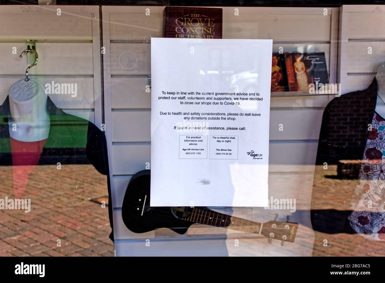 Warminster, Wiltshire / UK - April 15 2019: A Closed due to Coronavirus sign in the window of the Age UK Charity Shop in Warminster, Wiltshire, UK Stock Photo